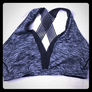 Grey sports bra with black mesh details.